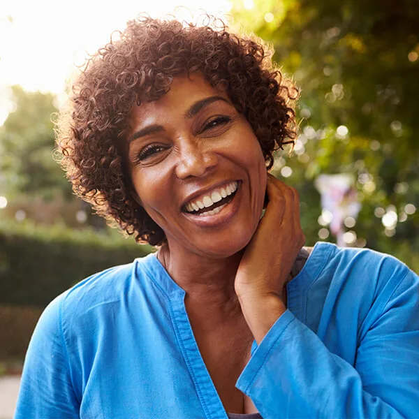 A woman smiles after dental treatment